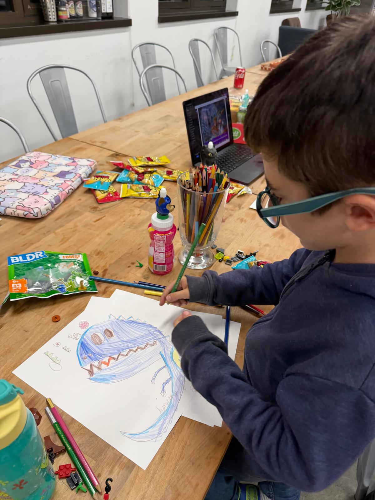 Child drawing, extending the story by hand